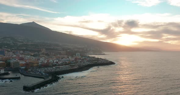 Aerial Panorama of Puerto De La Cruz Resorts and Pools Surrounded By Sea Waves on Sunset Tenerife