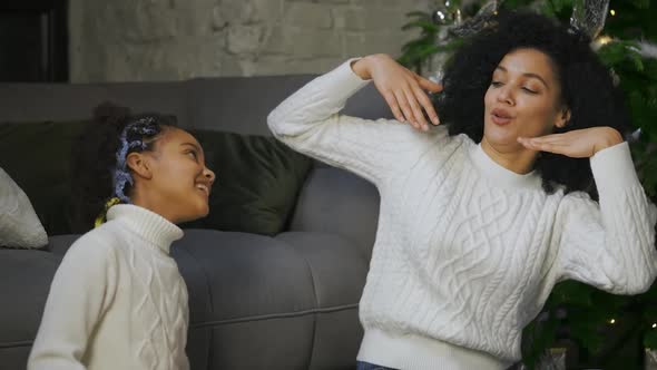 Portrait of African American Mom and Her Little Daughter Funny Dancing and Smiling