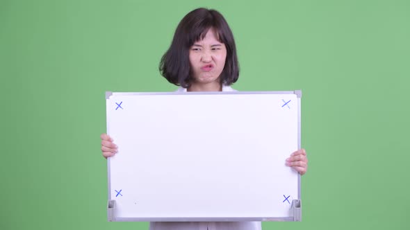 Stressed Asian Businesswoman Holding White Board