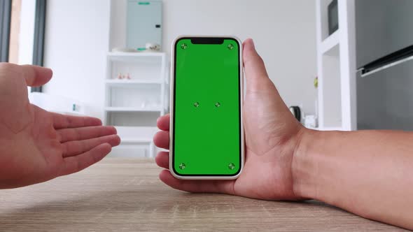 POV View Shoot of Young Man Holding Smartphone with Green Screen Chroma Key and Having a Video Call