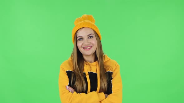 Portrait of Modern Girl in Yellow Hat Is Listening Attentively and Nodding His Head Pointing Finger