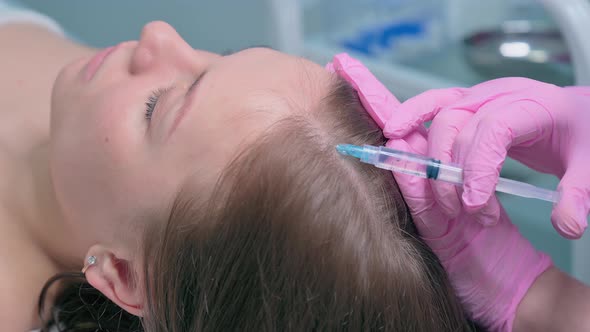 Doctor Making Injections Mesotherapy in Woman Skin Head for Hair Growth