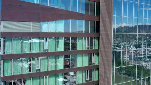 Aerial Drone Pan Shot Left To Right of Reflection in Glass Building in Tbilisi