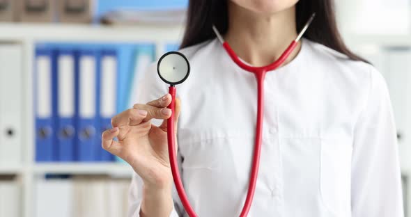 Female Doctor Holding Red Stethoscope in Clinic Closeup  Movie Slow Motion