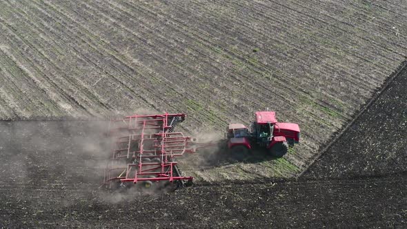 Aerial View of a Tractor Plows Field