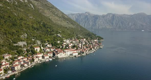 Aerial shot of Perast in Montenegro, on the Bay of Kotor with a mountain ridge in the distance