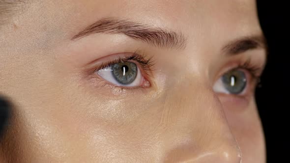 Applying Foundation on the Face. Black. Closeup