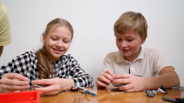 Boy and Girl Having Fun Using Building Kit