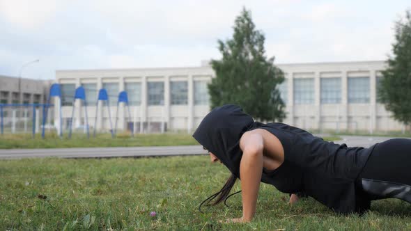 Sporty Woman Doing Pushups with Cotton on the Stadium