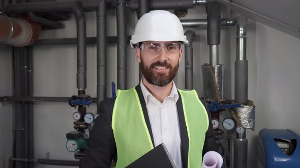 Concentrated Adult Man Engineer Looking at Camera Positive