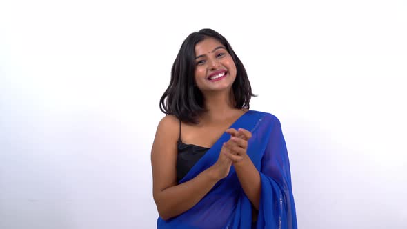 Proud Indian woman clapping in saree