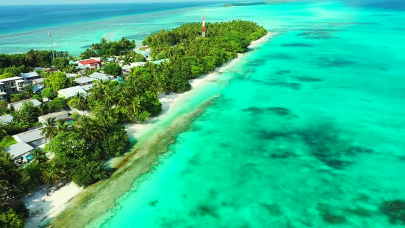 Aerial flying over seascape of perfect tourist beach break by blue lagoon and white sand background 