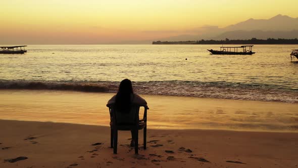 Women tan on idyllic resort beach wildlife by shallow ocean and clean sand background of Bali near r