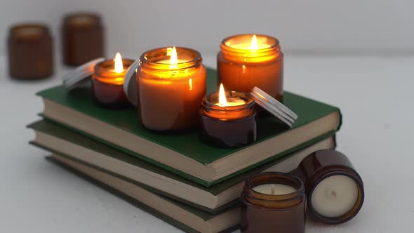 A Set of Different Aroma Candles in Glass Jars on a White Background