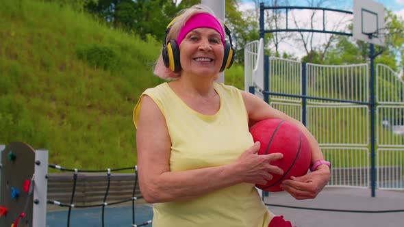 Senior Woman Grandmother After Sport Basketball Training Sitting Listening Music on Playground Court