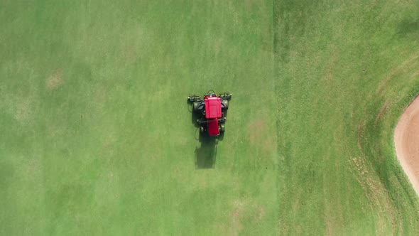 Gardener Cuts Green Grass on Perfect Golf Course