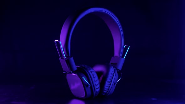 Wireless music headphones in beautiful purple neon light