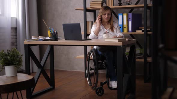 Disabled Female Talking with Clients on Cellphone