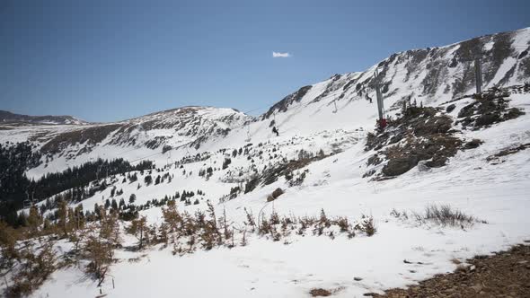 Ski lift taking skiers and snowboarders to the top of the mountains during the spring