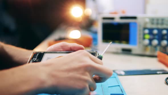 Repairman Disassembling Smartphone Screwdriver