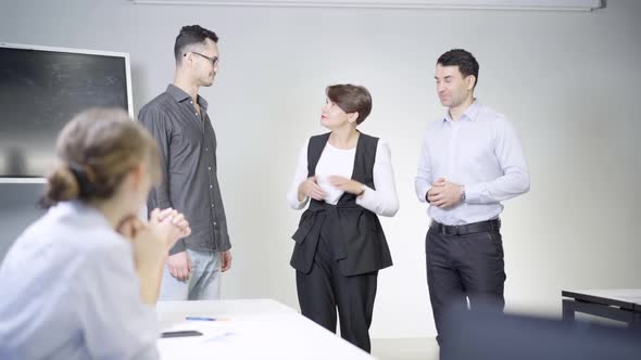 Business People Clapping As Confident Caucasian Woman Talking in Meeting Room