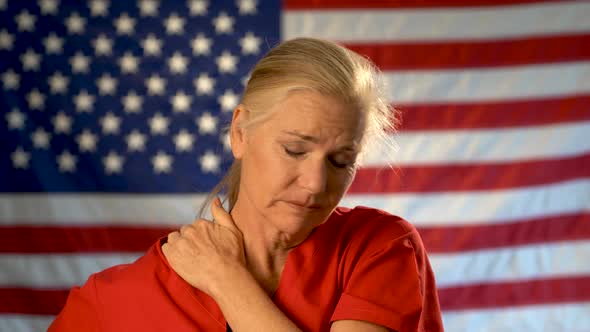 Medium tight portrait of nurse looking overwhelmed and stressed, hands on her head, shaking her head