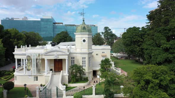 Aerial trucking shot to left of the Casa Museo Quinta Montes Molina on the Paseo Montejo in Merida,