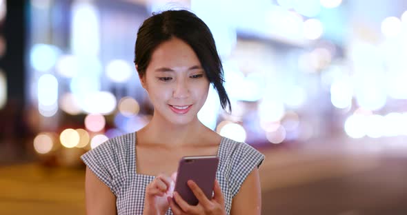 Woman Use of Mobile Phone for Mobile App at Night