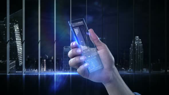 Hand holding futuristic mobile phone against digitally generated background