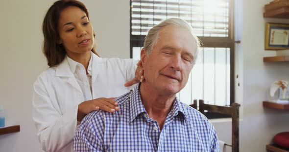 Senior man receiving neck massage from physiotherapist 4k