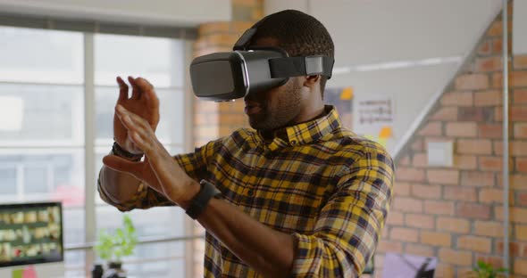 Male graphic designer using virtual reality headset in office 4k