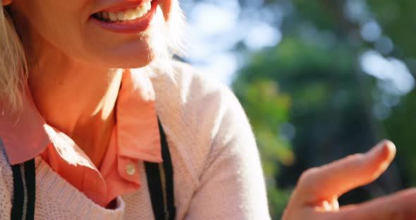 Mature woman checking plant