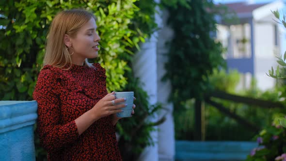 Woman on Backyard of Villa Touching Delicate Flowers Plants of Blooming Trees Growing Outdoor Rbbro