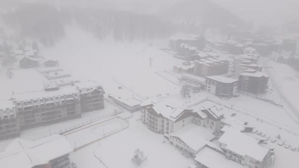 Flying over mountain resort Crystal in Bakuriani. Snowy winter day. Georgia