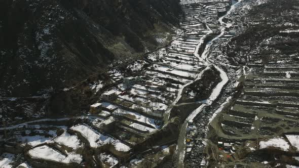 Drone Flying Over Snow Covered Terraces In Hunza Valley. Circle Dolly