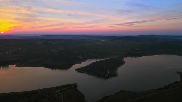Aerial drone view of the Duruitoarea natural reservation at sunset in Moldova. River and village, hi