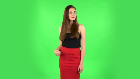 Young Woman Stands Waiting on Green Screen