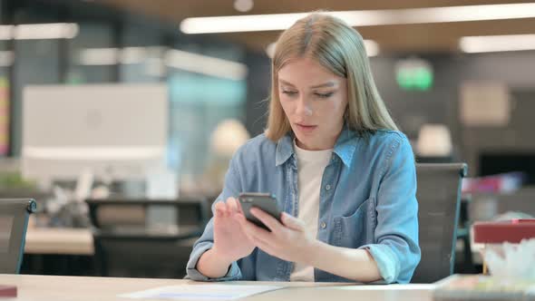 Successful Young Woman Celebrating on Smartphone