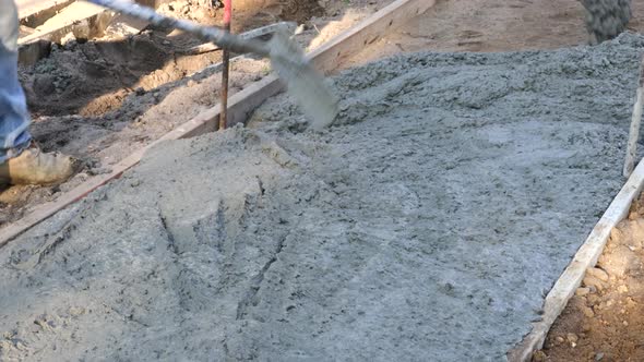 Laying Down a New Sidewalk in Wet Concrete on Freshly Poured Sidewalks Mason Building