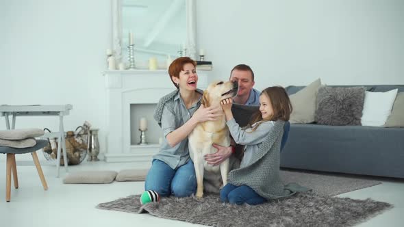 Family Enjoying Home Life with Their Labrador Dog