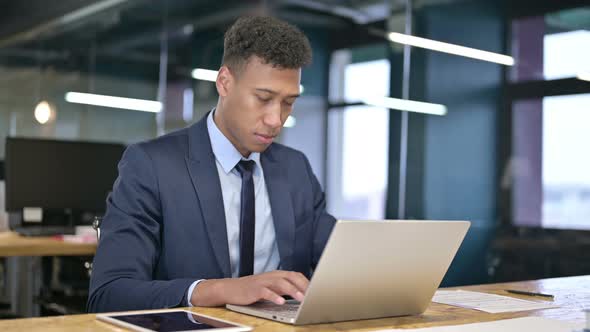 Focused Young Businessman Working on Laptop