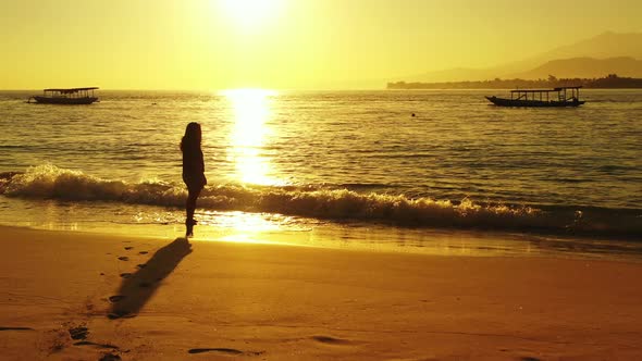 Pretty beauty model on holiday in the sun on beach on sunny blue and white sand 4K background