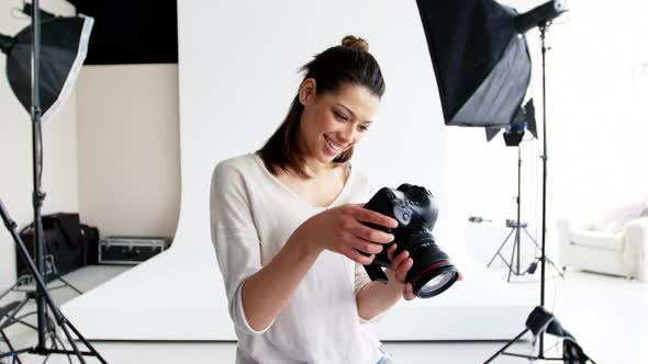 Photographer looking at photos on digital camera