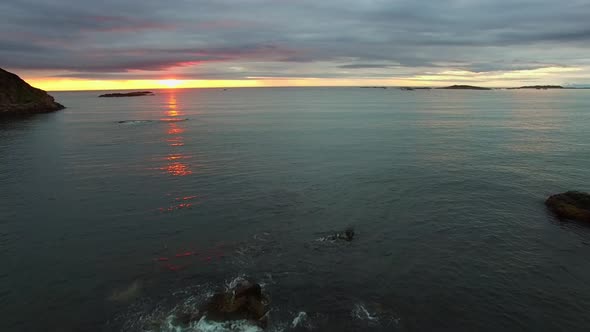 Rocky coast and midnight sun in Norway.