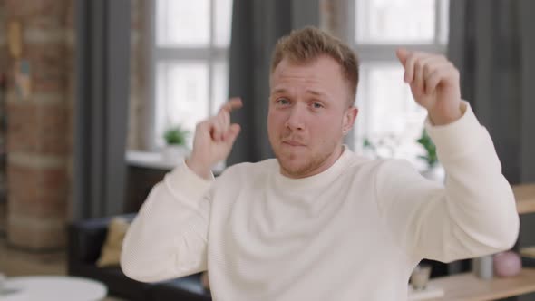 Happy Man Dancing to Music at Home