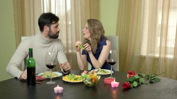 Woman Feeding Man Grapes