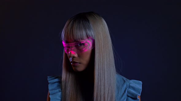 Young woman looking through futuristic light therapy glasses