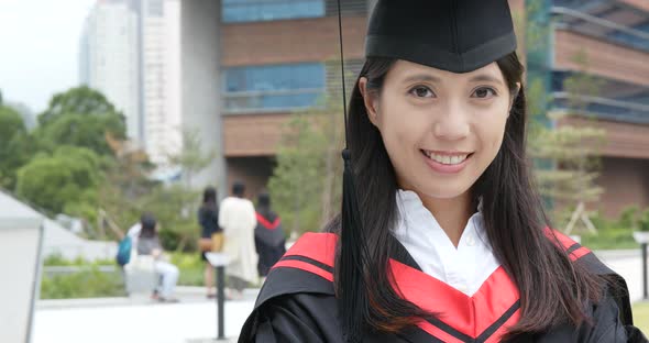 Cheerful woman with graduation gown