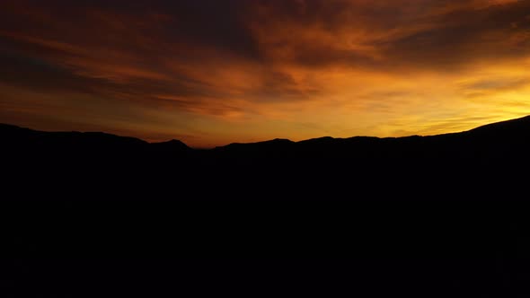 Mountain Range Horizon Early Sunrise Aerial Pan Shot 4K