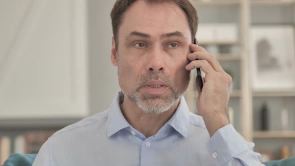 Old Businessman Talking on Phone